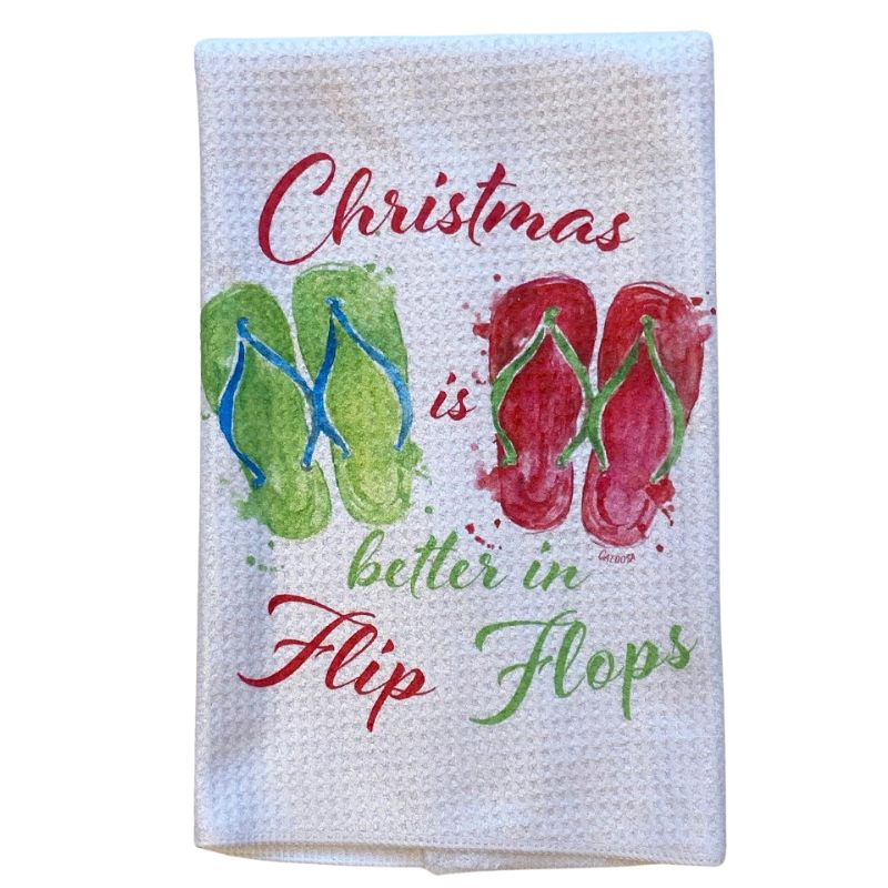 White waffle textured dish towel with "Christmas is Better in Flip Flops" written on the front. Towel measures 16" x 24".