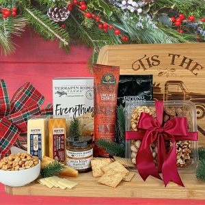 A variety of cheese and meat with all the accompaniments delivered on a large bamboo cutting board with a touch of holiday magic.