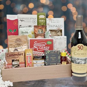 A thoughtful holiday gift basket filled with sweet and savory treats with a bottle of wine!