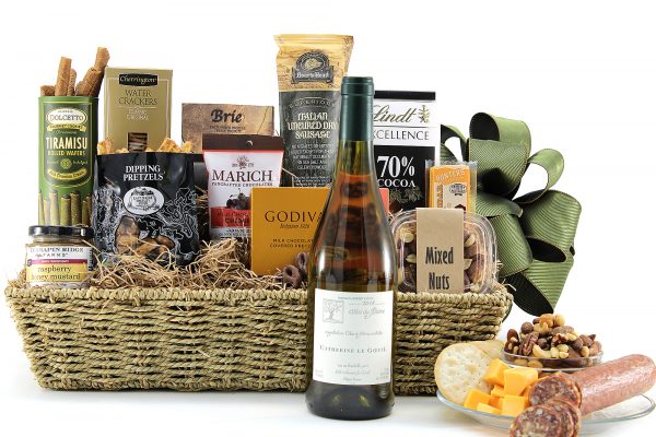 Gourmet gift basket with a variety of chocolate, meat, cheese, salty snacks, and a bottle of wine