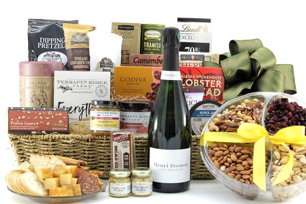 Large gourmet gift basket filled with a wide variety of sweet, salty, and savory snacks with a bottle of wine.