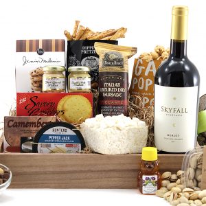 Gourmet gift basket with assorted sweet and salty snacks delivered with a bottle of wine.