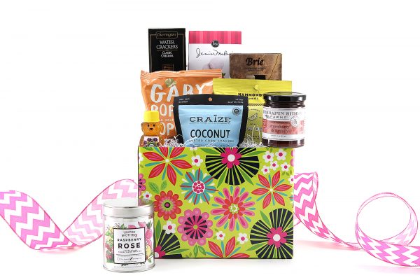 Brightly colored floral print gift basket filled with a variety of treats including gourmet jam, local Florida honey, and so much more!