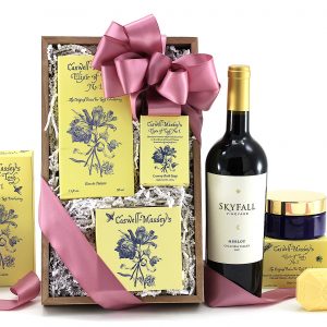 Gift basket delivered with a bottle of wine plus self-care products for her. Products from the "Elixir Of Love" collection from Caswell - Massey.
