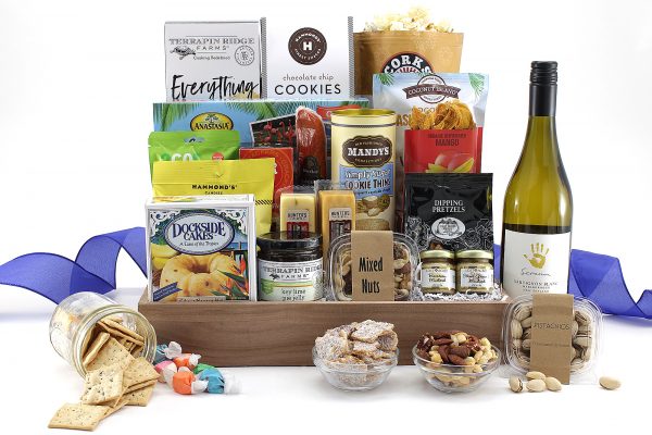 An overflowing gift basket of assorted sweet and salty snacks and a bottle of wine of your selection!