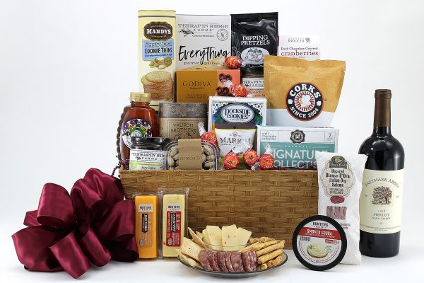 A gift basket of thoughtful treats with a bottle of wine.