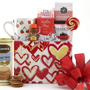Valentine's Day gift basket filled with a variety of sweet treats, tea bags, and a festive ceramic mug.