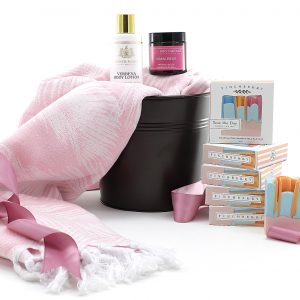 A snuggly Mother's Day gift basket with a blanket and bath products.