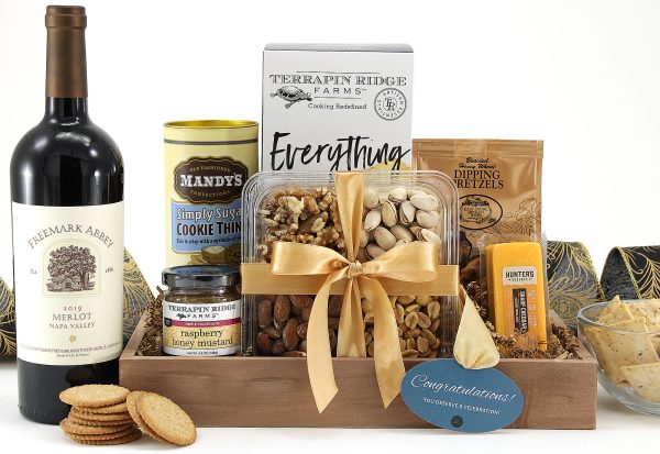 A gift basket filled with a variety of treats, a bottle of wine, and a message of congratulations!