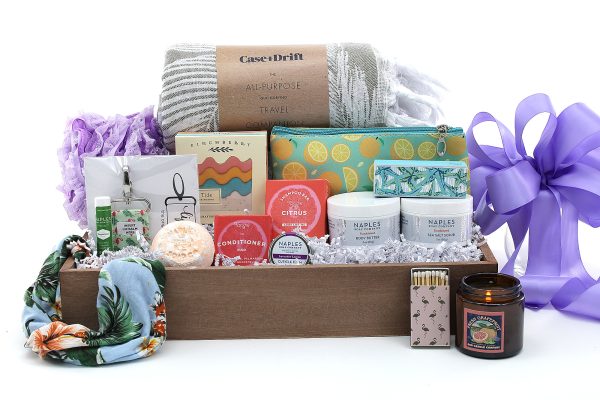 A large gift basket overflowing with bath, spa, and self-care products.