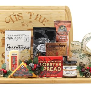 A festive charcuterie board of cheeses, meats, salty snacks, and more displayed on top of a festive cutting board.