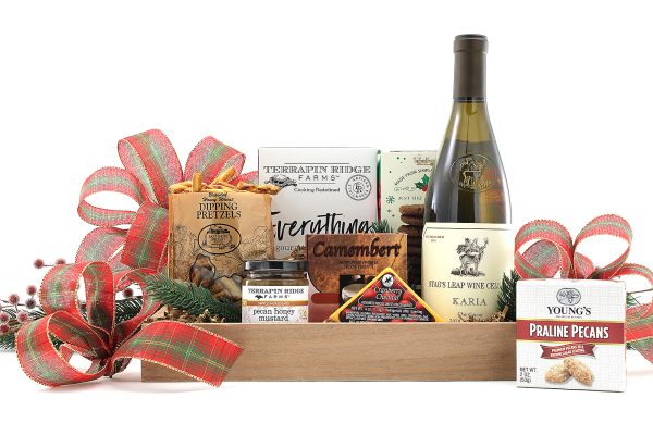 A perfectly sized gift basket full of gourmet goodies, a bottle of wine, and a touch of holiday flair!