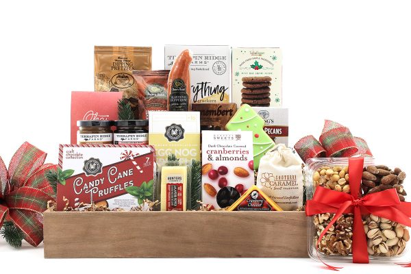 A large gift basket full of gourmet goodies and a touch of holiday flair!