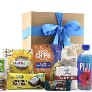 Embark on a taste journey with 'Traveling Treats' gift basket. Discover Kind Bars, Lemon Wafer Bites, Seed Crisps, and more, beautifully packed in a kraft gift box with a handcrafted bow.