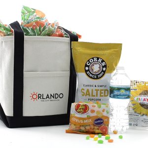 "Enjoy Spring Break in Orlando with our small tote: Salted Popcorn, Jelly Belly Citrus Mix, Seed Crisps, and Zephyrhills water. Orlando vibes, packed for your getaway!